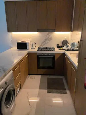 a kitchen with a stove and a microwave at 10 min to Burj Khalifa 1BR in Hotel-style building Luxury Stay in Dubai