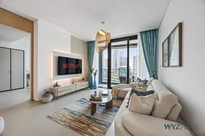 a living room with a couch and a tv at Deluxe 1 BR in The Address JBR Beachfront Access in Dubai