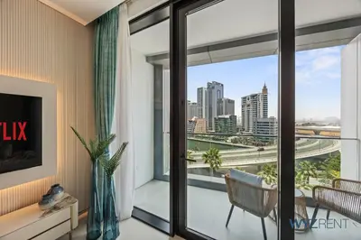 a living room with a large window with a view of the city at Deluxe 1 BR in The Address JBR Beachfront Access in Dubai