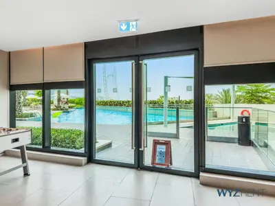 a view of a pool from a room with sliding glass doors at Deluxe 1 BR in The Address JBR Beachfront Access in Dubai