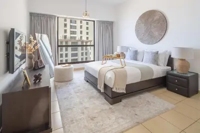 a bedroom with a bed and a large window at Frank Porter - Sadaf 7, JBR in Dubai