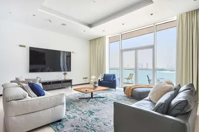 a living room with two couches and a tv at Frank Porter - Tiara Residence Diamond North 4 in Dubai