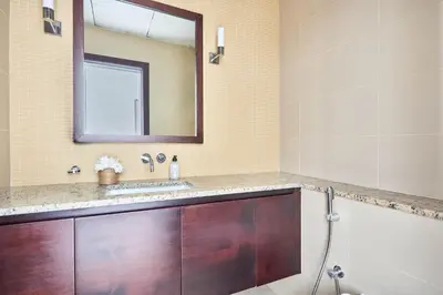 a bathroom with a sink and a mirror at Frank Porter - Tiara Residence Diamond North 4 in Dubai
