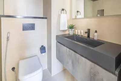 a bathroom with a sink and a toilet at Frank Porter - Marina Wharf 1 in Dubai