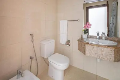 a bathroom with a toilet and a sink at Frank Porter - Lakepoint N2 in Dubai