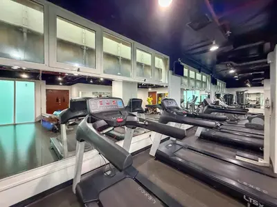 a row of treadmills in a gym at Frank Porter - Lakepoint N2 in Dubai