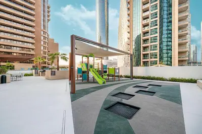 a playground in a city with tall buildings at Marina Horizon by LIV High Floor 1BR, For 5 Guests, Dual Gyms & Marina View in Dubai