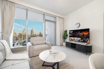 a white living room with a large window at Marina Horizon by LIV High Floor 1BR, For 5 Guests, Dual Gyms & Marina View in Dubai