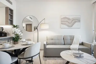 a living room with a couch and a table at Marina Horizon by LIV High Floor 1BR, For 5 Guests, Dual Gyms & Marina View in Dubai