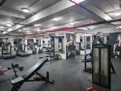 a gym with several treadmills and machines at Vogue Business Bay - Bay Square Close to Downtown, Burj Khalifa and Dubai Mall, Studio Apartment with Balcony and City View, Access to all Amenities in Dubai