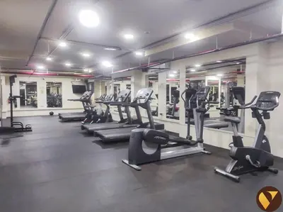 a gym with treadmills and ellipticals in a room at Vogue Business Bay - Bay Square Close to Downtown, Burj Khalifa and Dubai Mall, Studio Apartment with Balcony and City View, Access to all Amenities in Dubai