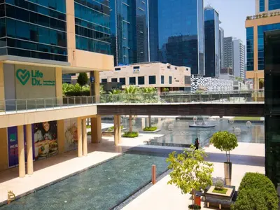 an overhead view of a building with a pool at Vogue Business Bay - Bay Square Close to Downtown, Burj Khalifa and Dubai Mall, Studio Apartment with Balcony and City View, Access to all Amenities in Dubai