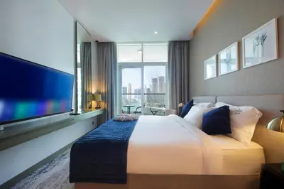 a hotel room with a bed and a large window at King Bed Suite - Canal Views - Pool, Gym & Balcony in Dubai