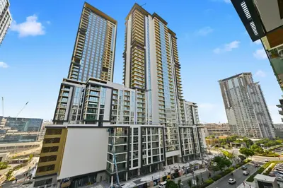 a tall building in a city with a street at New Cozy Studio, Ideal for 2 in Kensington Waters in Dubai