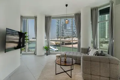 a living room with a couch and a large window at Modern 2 Bedroom in Dubai Marina - Sea View in Dubai