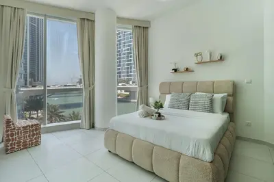 a bedroom with a large bed and a large window at Modern 2 Bedroom in Dubai Marina - Sea View in Dubai