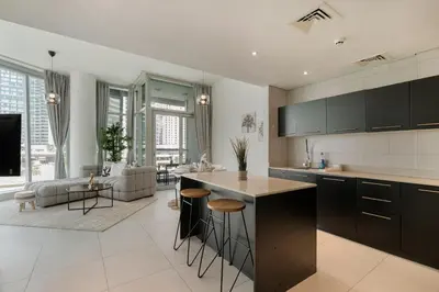 an open kitchen and living room with a couch at Modern 2 Bedroom in Dubai Marina - Sea View in Dubai