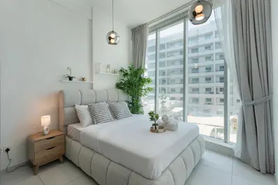 a bedroom with a bed and a large window at Modern 2 Bedroom in Dubai Marina - Sea View in Dubai