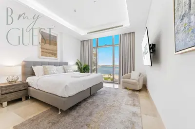 a bedroom with a large bed and a large window at Stunning Full Sea View 3BR Luxurious Palm Jumeirah in Dubai