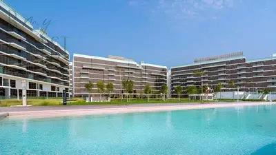 an empty swimming pool in front of a building at Stunning Full Sea View 3BR Luxurious Palm Jumeirah in Dubai
