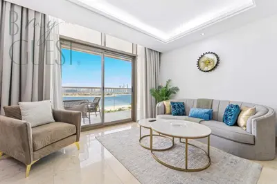 a living room with a couch and chairs and a table at Stunning Full Sea View 3BR Luxurious Palm Jumeirah in Dubai