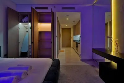 a purple room with a bed and a bathroom at Stylish Studio with Stunning City Views in Dubai