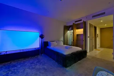 a bedroom with a large screen on the wall at Stylish Studio with Stunning City Views in Dubai