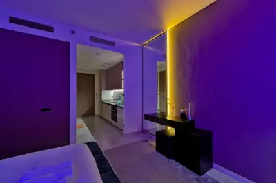 a purple room with a couch and a table at Stylish Studio with Stunning City Views in Dubai