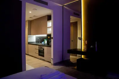 a purple room with a kitchen with a stove top oven at Stylish Studio with Stunning City Views in Dubai
