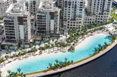 an aerial view of a resort with a large pool at StayShort - Dubai Creek Harbour sleeps 6 in a Great Location in Dubai