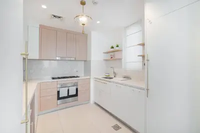 a kitchen with white cabinets and a stove at StayShort - Dubai Creek Harbour sleeps 6 in a Great Location in Dubai