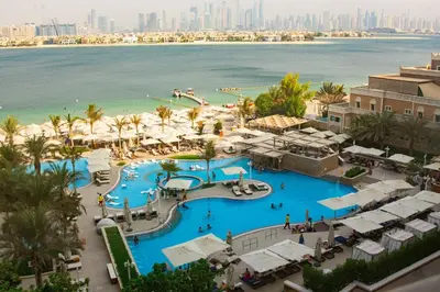 an aerial view of a resort with a large pool at SettlerHomes - Seaside Lux Escape With Calm Sea View in Dubai