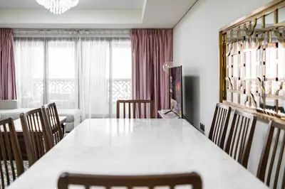 a dining room with a large white table and chairs at SettlerHomes - Seaside Lux Escape With Calm Sea View in Dubai