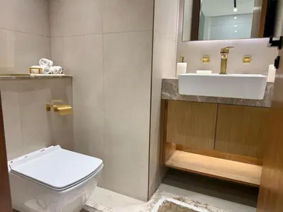 a bathroom with a white toilet and a sink at Modern 1BD APT In Binghatti Burj Khalifa Skyline in Dubai