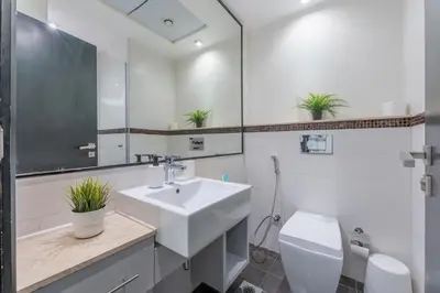 a white bathroom with a sink and a toilet at Luxury 3BR Dubai Marina Sea & Ain Dubai View in Dubai