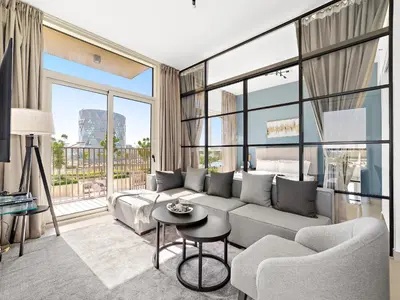 a living room with a couch and a table at Classic Luxe 2BDR in Collective in Dubai