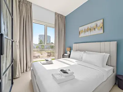 a bedroom with a large white bed and a window at Classic Luxe 2BDR in Collective in Dubai