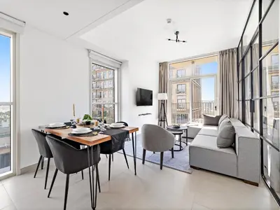 a living room with a table and a couch at Classic Luxe 2BDR in Collective in Dubai