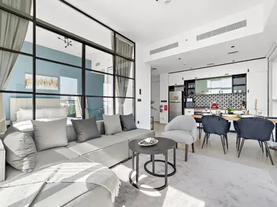 a living room with a couch and a table at Classic Luxe 2BDR in Collective in Dubai