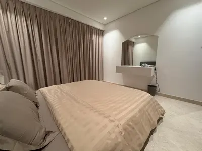 a bedroom with a large bed and a mirror at Mahenti - Mesmerizing views of The Burj & Downtown Dubai in Dubai