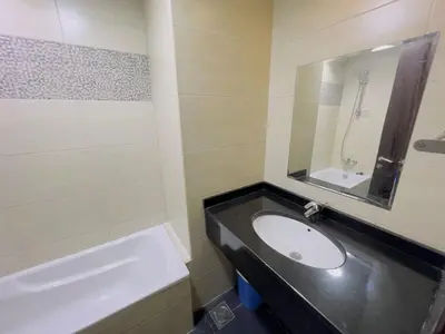 a bathroom with a sink and a tub and a mirror at Mahenti - Elite 1 · Large balcony with all u need in Dubai