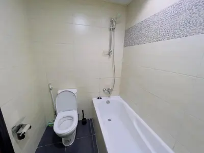 a bathroom with a toilet and a bath tub at Mahenti - Elite 1 · Large balcony with all u need in Dubai