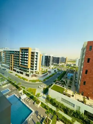 an aerial view of a city with buildings and a pool at Mahenti – Elegant Studio Apartment | Azizi Riviera in Dubai