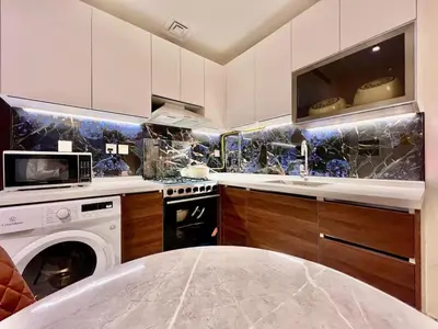 a kitchen with a sink and a stove top oven at Mahenti - Bright studio near Miracle Garden in Dubai