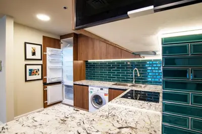 a kitchen with a washer and a sink and a dishwasher at Stylish 2BR Balcony Palm Jumeirah Views in Dubai