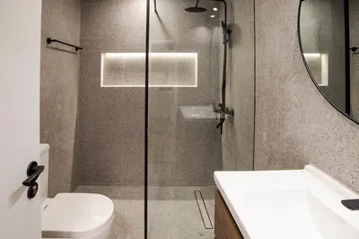 a bathroom with a shower and a toilet and a sink at Stylish 2BR Balcony Palm Jumeirah Views in Dubai