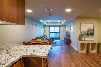 a kitchen and a living room with a couch at Stylish 2BR Balcony Palm Jumeirah Views in Dubai
