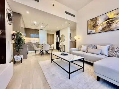a living room with a couch and a table at Mahenti- Chic 1BR with Burj & Downtown View in Dubai