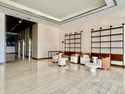 a lobby with couches and chairs in a building at Mahenti- Chic 1BR with Burj & Downtown View in Dubai