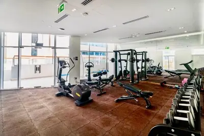a gym with several treadmills and exercise bikes at Mahenti - 1BR - Stunning Lake & Burj Khalifa Views in Dubai